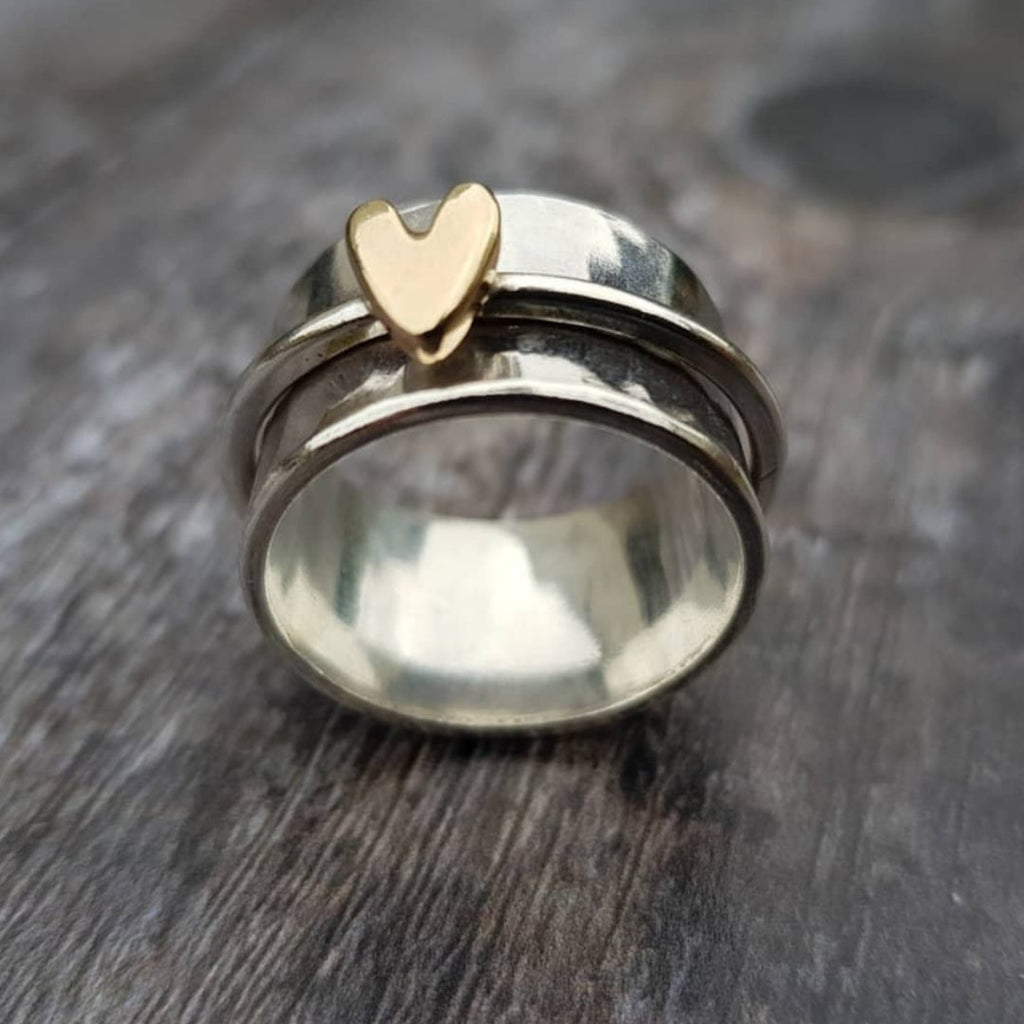 Silver ring with gold heart