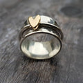 Silver ring with gold heart