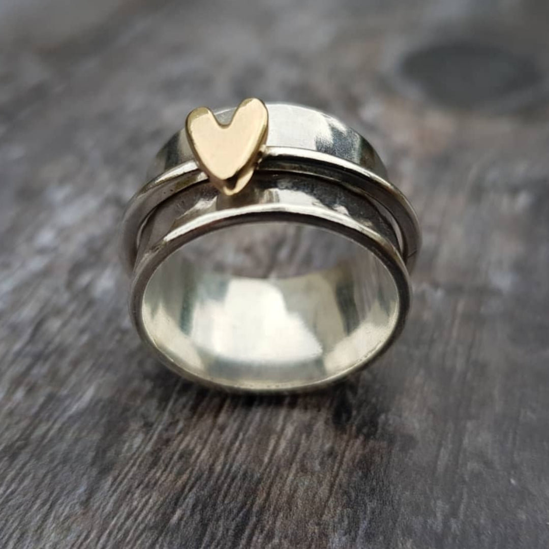 Silver ring with gold heart