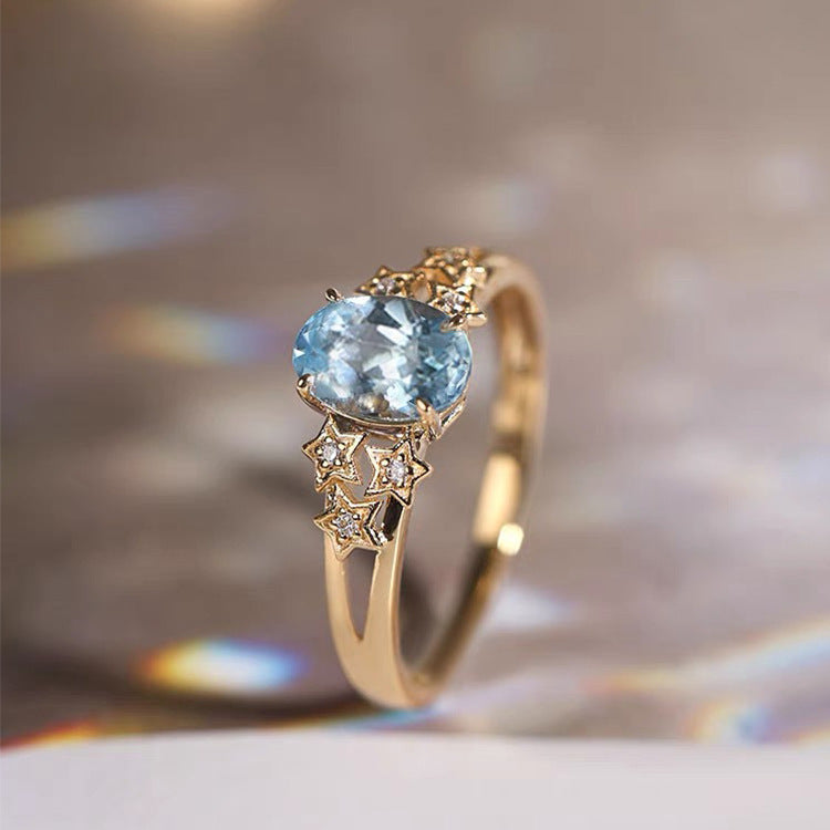 Exclusive gold ring with blue crystal